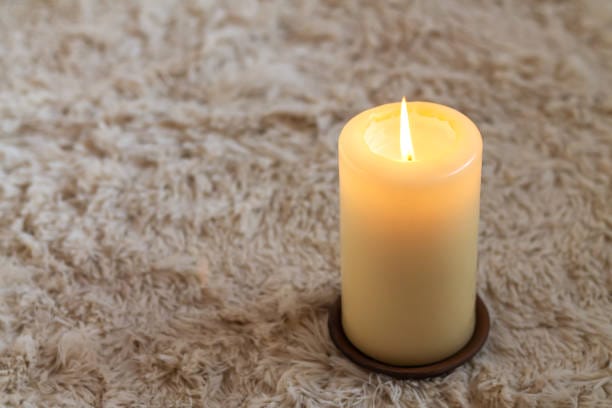 burning candle on carpet